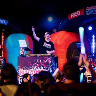 Three DJs on a stage at a Silent Disco event